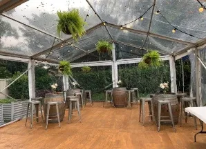 natural timber flooring inside a clear marquee for a party